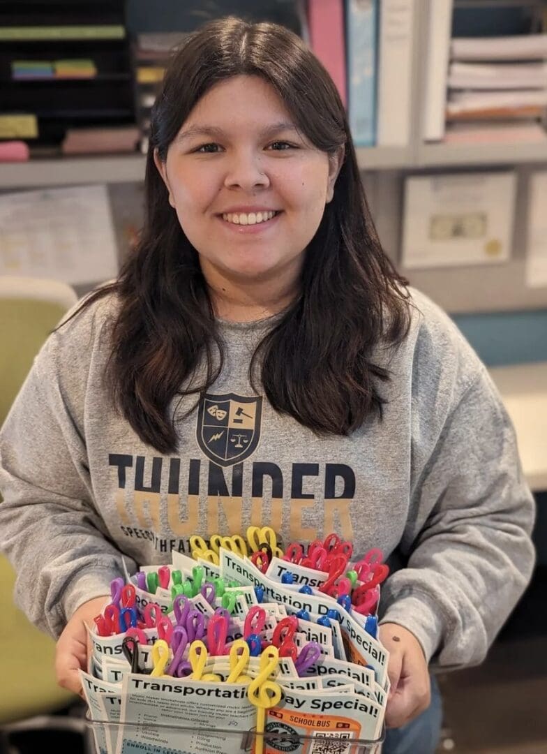 A girl holding a cake with candles on it.