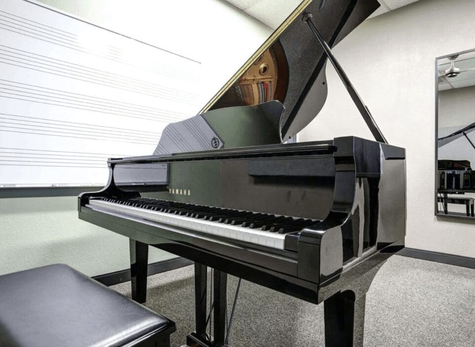 A person sitting at the piano in an office.