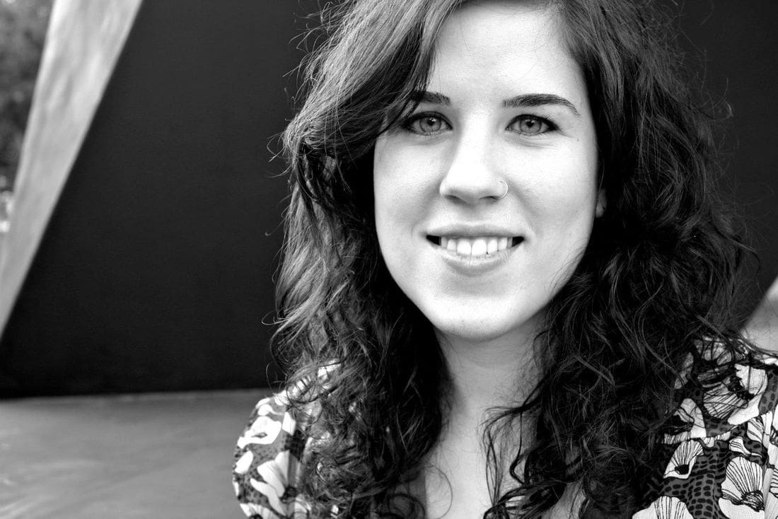 A woman with long hair smiling for the camera.