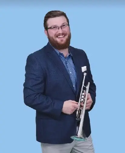 A man holding a trumpet in his hands.