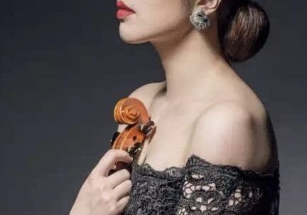 A woman holding a violin in her hand.