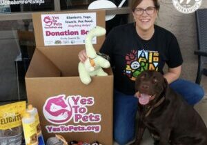 Ms. Shelley with her dog Reggie.  Donating toys and food for pets.